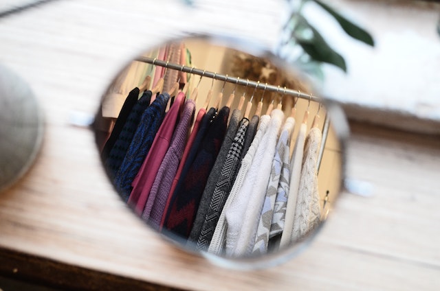 A mirror reflecting a well-organized closet