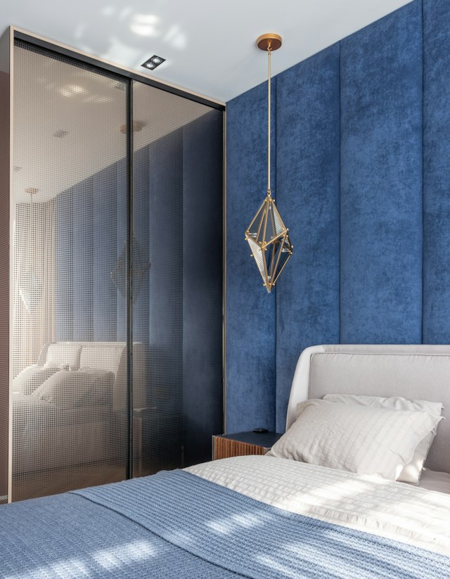 Geometrical pendant lighting in a blue palette bedroom