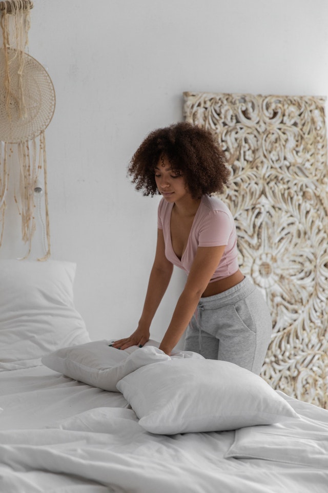 Woman changing the pillow covers