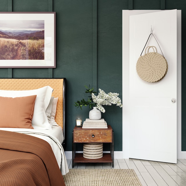 bedroom with a green accent wall and lots of brown, earthy tones